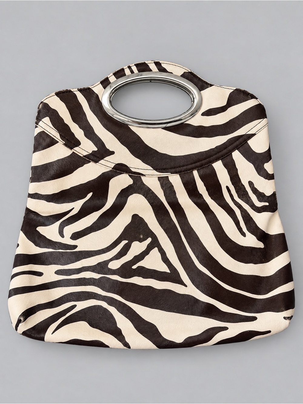 Y2K-style zebra-print fold-over clutch/handbag with an oval metal handle